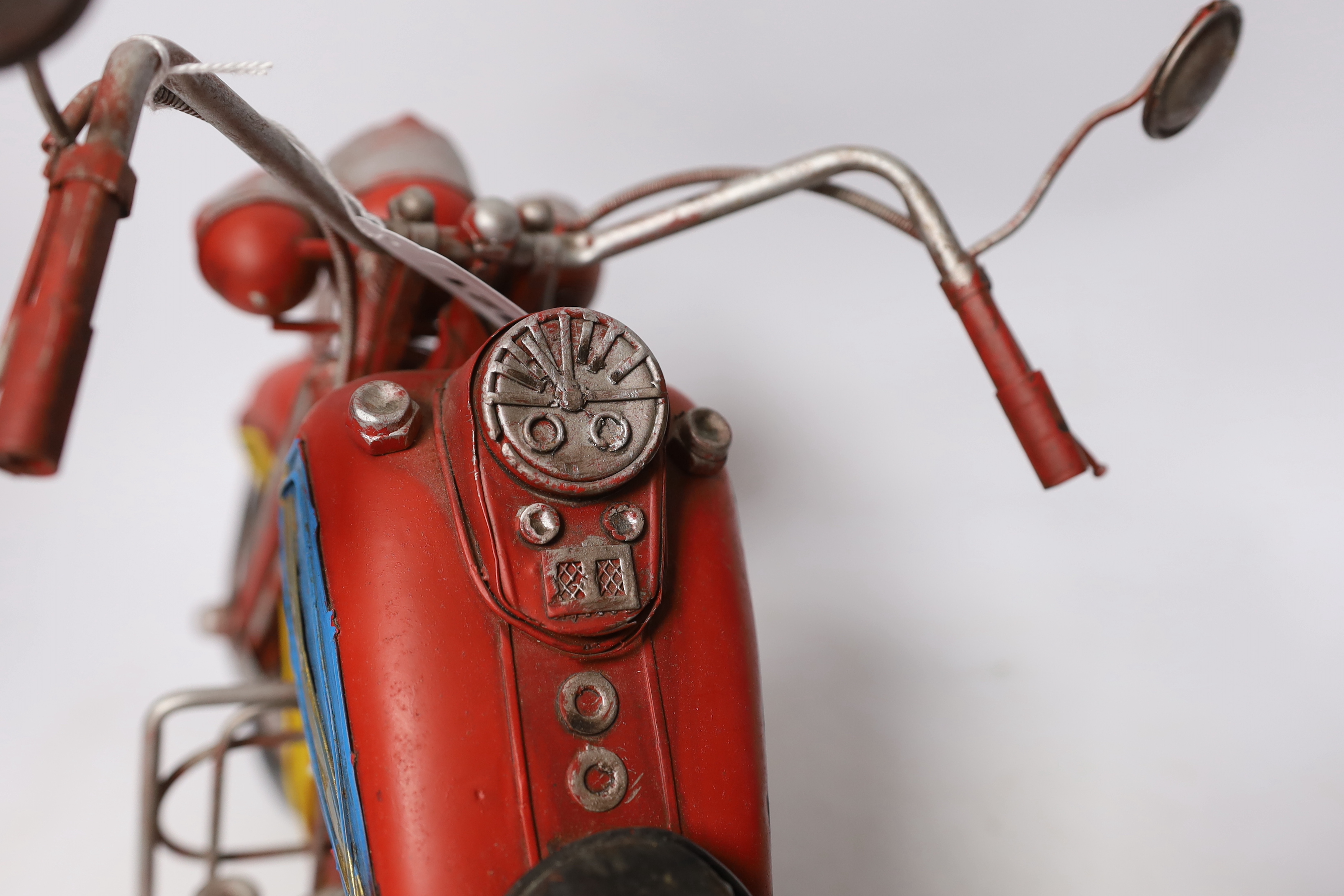 A faux tinplate motorcycle, 54cm long